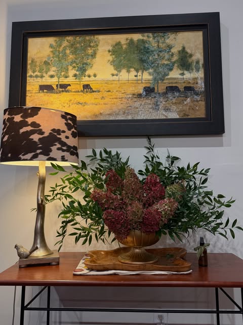 Natural foliage and richly textured flowers in a table arrangement