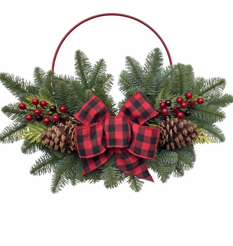 Red metal hoop wreath with evergreen, pinecones and a buffalo plaid bow